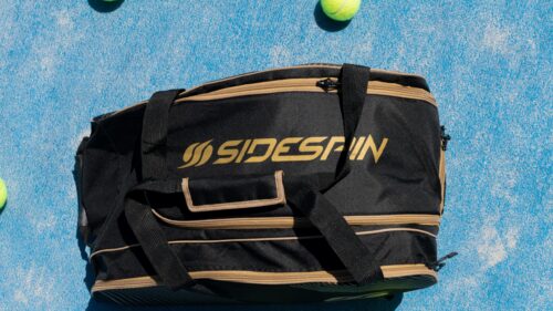 Black and Gold Sidespin Paddle Tennis Bag on Blue Court 4K Wallpaper