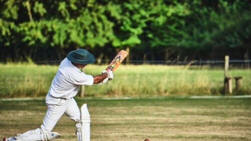 Classic Cricket Player Swinging the Bat Action Desktop Wallpaper