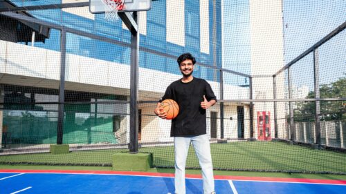 Young Man Holding Basketball on Outdoor Sports Court 4K Wallpaper