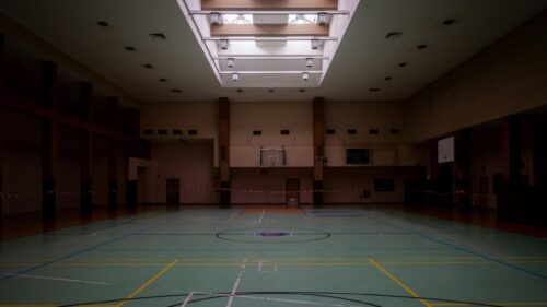 Empty Indoor Basketball Court with Overhead Skylights 4K Wallpaper