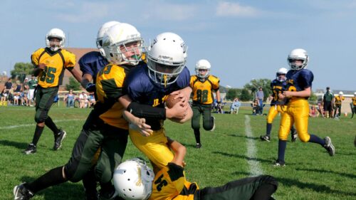 Intense Youth Football Game Action Shot Desktop Wallpaper