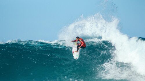 Professional Surfer Riding Massive Ocean Wave Desktop Wallpaper