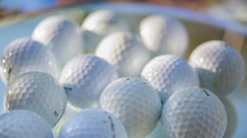 Macro Shot of Professional Golf Balls on Glass Surface 4K Wallpaper