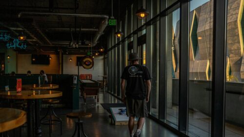 Man Walking in Modern Restaurant Interior 4K Wallpaper