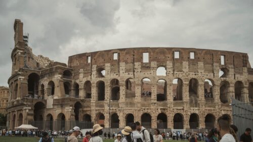Ancient Roman Colosseum Architecture Under Dramatic Cloudy Sky 4K Wallpaper