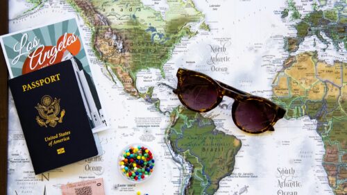 Travel Essentials on World Map Desk 4K Desktop Wallpaper