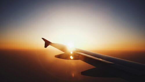 Airplane Wing Silhouette Against Golden Sunset 4K Desktop Wallpaper