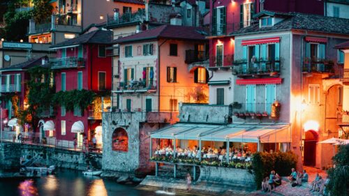 Charming Italian Lakeside Restaurant at Twilight Desktop Wallpaper