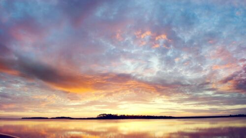 Breathtaking Sunset Over Calm Water Landscape 4K Wallpaper