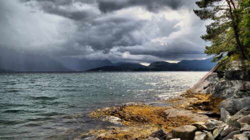 Dramatic Moody Norwegian Fjord Landscape with Stormy Clouds 4K Wallpaper
