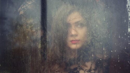 Melancholic Woman Looking Through Foggy Glass Window Desktop Wallpaper