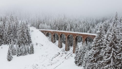 Stunning Stone Railway Viaduct in Snowy Winter Forest PC Wallpaper
