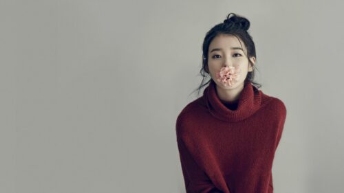 Stunning IU Portrait with Pink Flower in Red Sweater Desktop Wallpaper