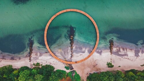 Aerial View of the Infinite Circular Wooden Bridge on Tropical Coast PC Wallpaper
