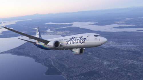 Alaska Airlines Boeing 737 Flying Over City at Sunset PC Wallpaper