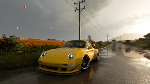 Stunning Yellow Porsche 911 400R on Rainy Scenic Road PC Wallpaper