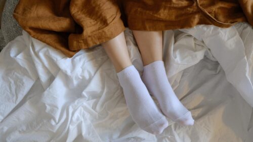 Cozy Morning Bedroom Scene with White Socks on Bed Desktop Wallpaper