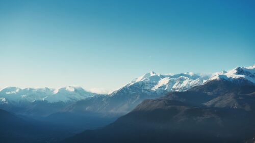 Minimalist Snowy Mountain Peaks under Clear Blue Sky Desktop Wallpaper