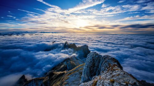 Breathtaking Mountain Peaks Above The Clouds at Sunset Desktop Wallpaper