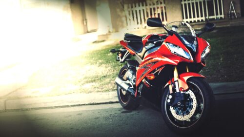Stunning Red Yamaha Sportbike Parked in Sunlight Desktop Wallpaper