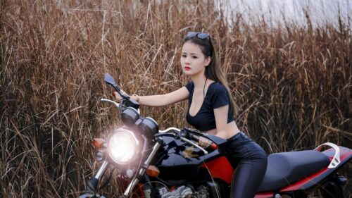Stunning Young Woman Posing on a Red Honda Motorcycle Desktop Wallpaper