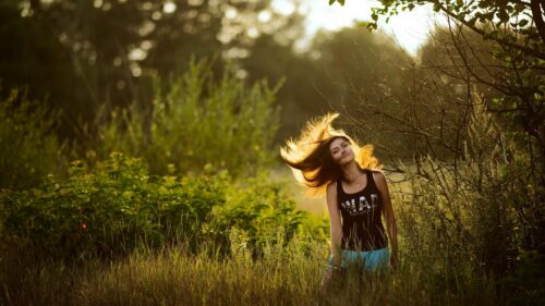 Beautiful Girl With Windblown Hair in Golden Hour Nature Setting Desktop Wallpaper