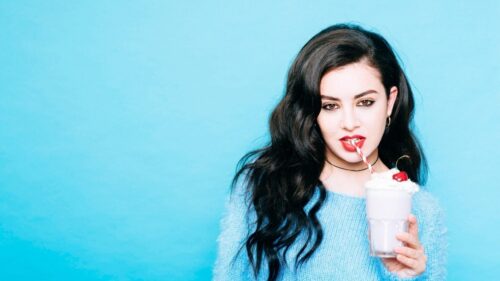Beautiful Girl Drinking Milkshake with Blue Background 4K Wallpaper