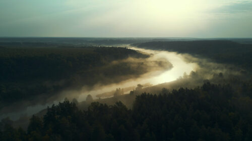 Misty River Winding Through Forest at Sunrise 4K Wallpaper