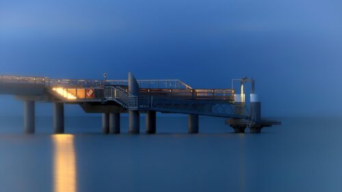 Minimalist Pier at Twilight Over Calm Ocean Waters Desktop Wallpaper