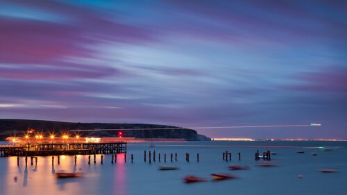 Long Exposure Coastal Pier Sunset with Purple Sky 4K Wallpaper