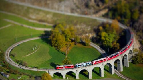 Tilt Shift Miniature Red Train on Stone Viaduct Bridge PC Wallpaper