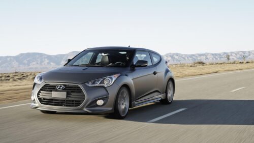 Matte Grey Hyundai Veloster Driving on Desert Highway PC Wallpaper