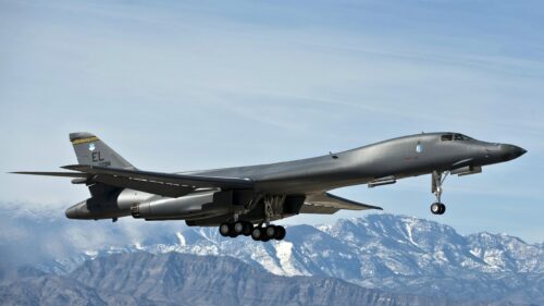 B-1B Lancer Strategic Bomber Flying Over Snowy Mountains PC Wallpaper