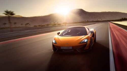 Stunning McLaren 570S Driving on Racetrack at Sunset 4K Wallpaper
