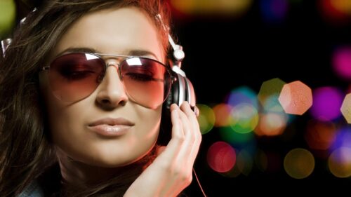 Stylish Woman Listening to Music with Headphones and Sunglasses PC Wallpaper