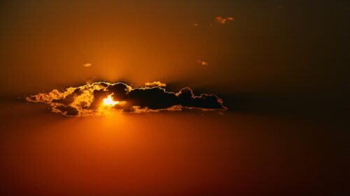 Stunning Golden Hour Sunset Behind Dark Clouds 4K Wallpaper