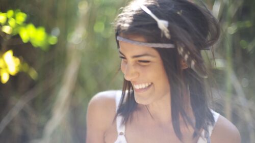 Beautiful Smiling Woman with Boho Feather Headband Desktop Wallpaper