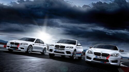 Three White BMW M Series Cars Racing on Track PC Wallpaper
