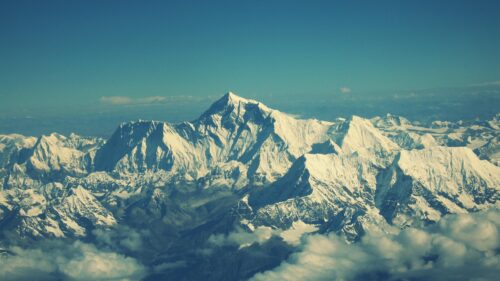 Breathtaking Aerial View of Majestic Snow Covered Mountain Peaks PC Wallpaper