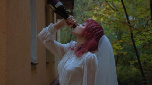 Stunning Pink Haired Woman Drinking From A Bottle In A White Lace Dress PC Wallpaper