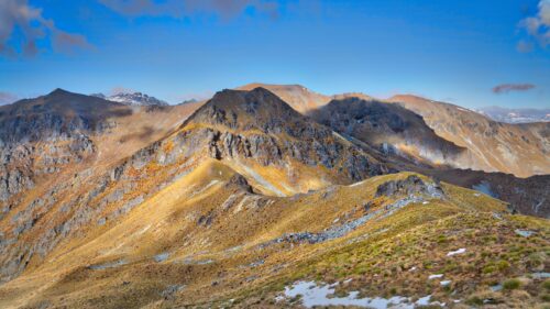 Stunning Golden Mountain Ridge Under Clear Blue Sky Desktop Wallpaper
