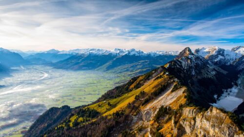 Breathtaking Alpine Mountain Valley View with Snow Capped Peaks PC Wallpaper