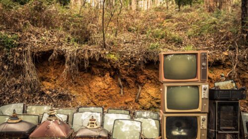 Vintage Abandoned Televisions in a Forest Clearing Desktop Wallpaper