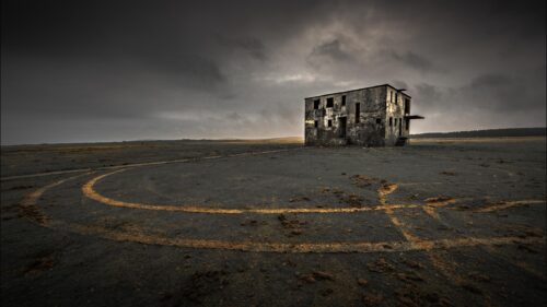 Abandoned Concrete Building in Moody Dark Landscape PC Wallpaper