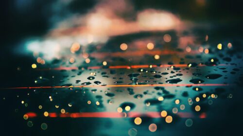 Raindrops on Glass with Cinematic Bokeh Light Reflections 4K Wallpaper