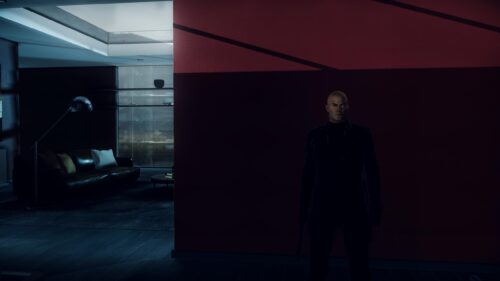 Agent 47 Hitman Standing in Shadows Dark Interior 4K Wallpaper