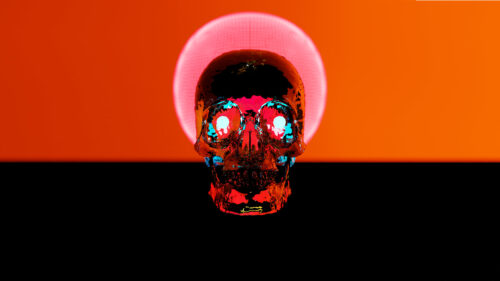Abstract Glowing Neon Skull with Orange Halo Background PC Wallpaper