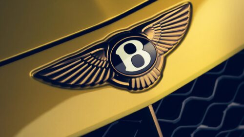 Stunning Bentley Logo Emblem on Yellow Luxury Car Hood Desktop Wallpaper
