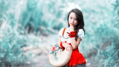 Beautiful Young Woman with Wicker Bag and Floral Accents Desktop Wallpaper