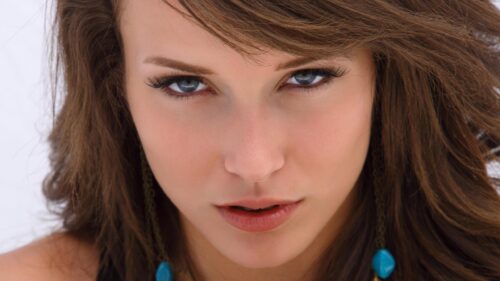 Stunning Portrait of a Woman with Piercing Blue Eyes Desktop Wallpaper